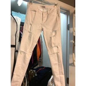Distressed white skinny jeans